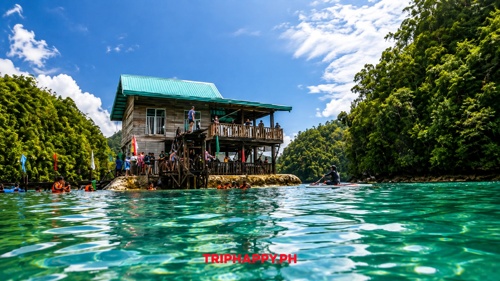 Wooden lagoon platform surrounded by turquoise water and tropical forest at Sugba Lagoon in Siargao