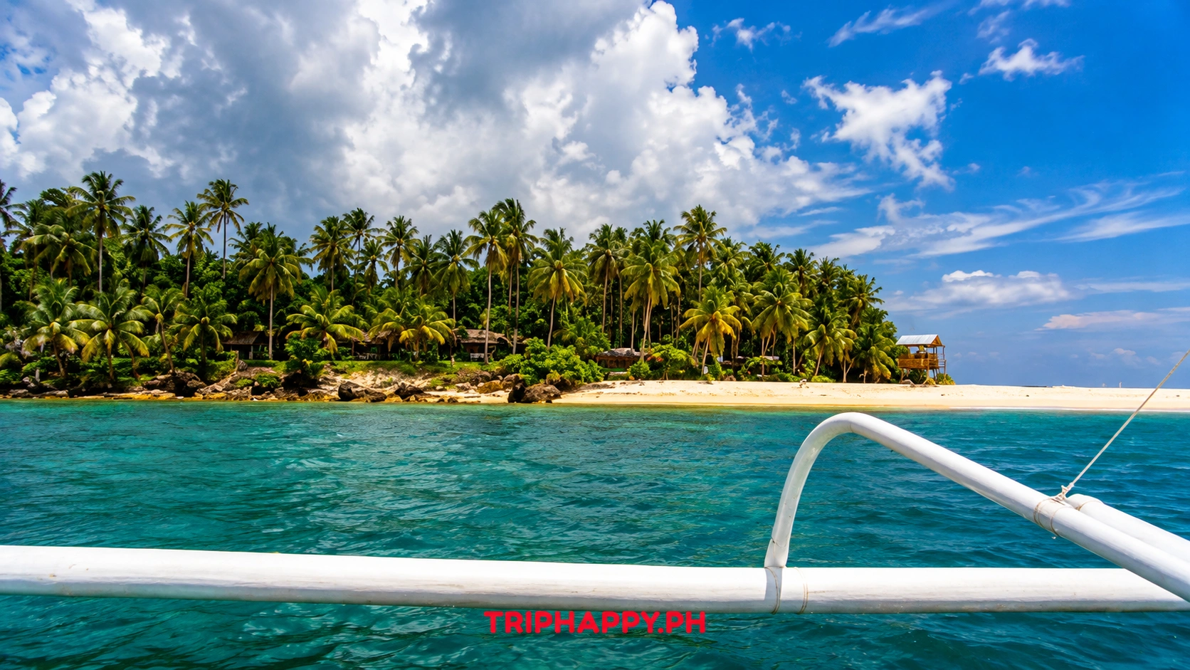 Tropical beach with palm trees and turquoise seawater near Sugba Lagoon in Siargao, Philippines