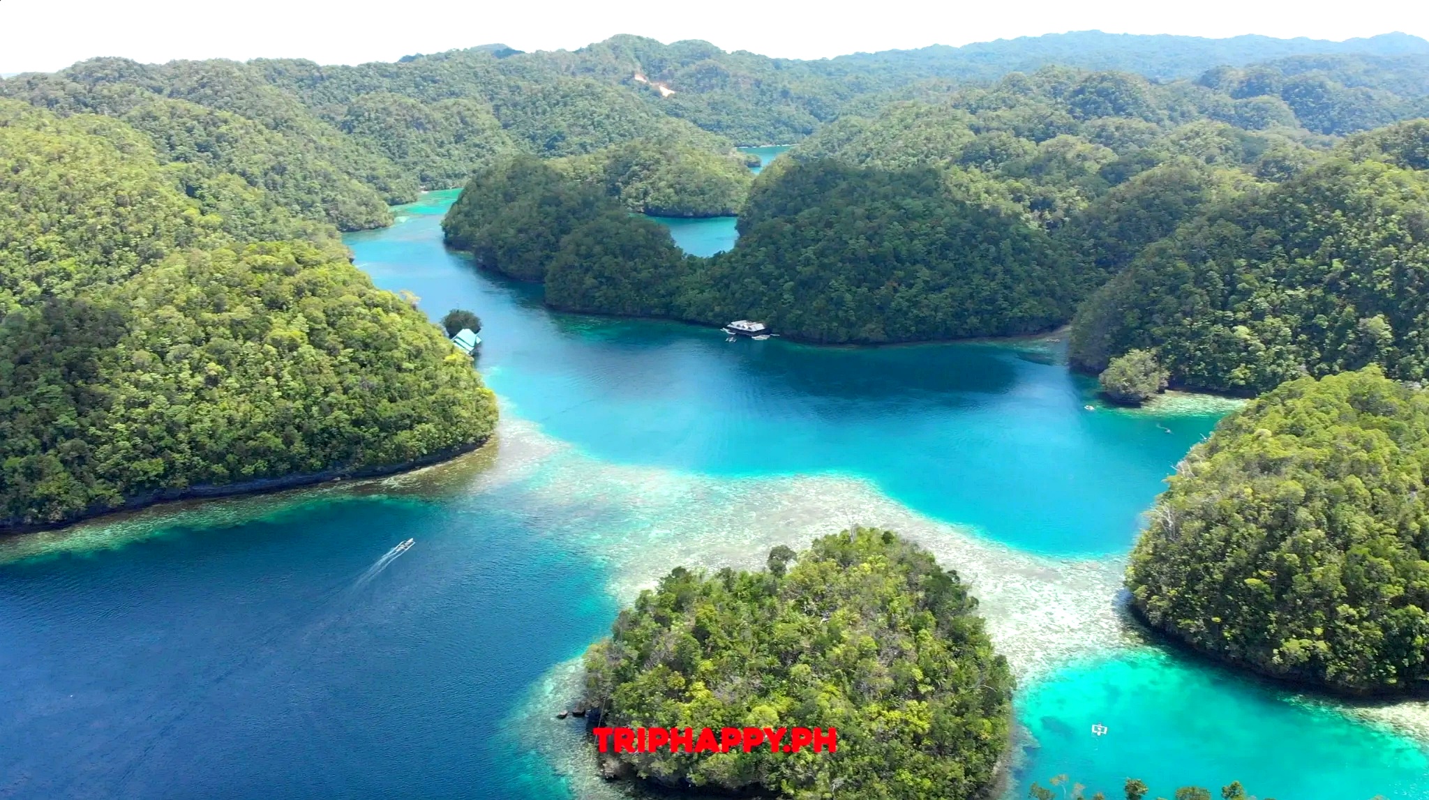 Admire the breathtaking turquoise lagoons and lush island landscapes of Bucas Grande.