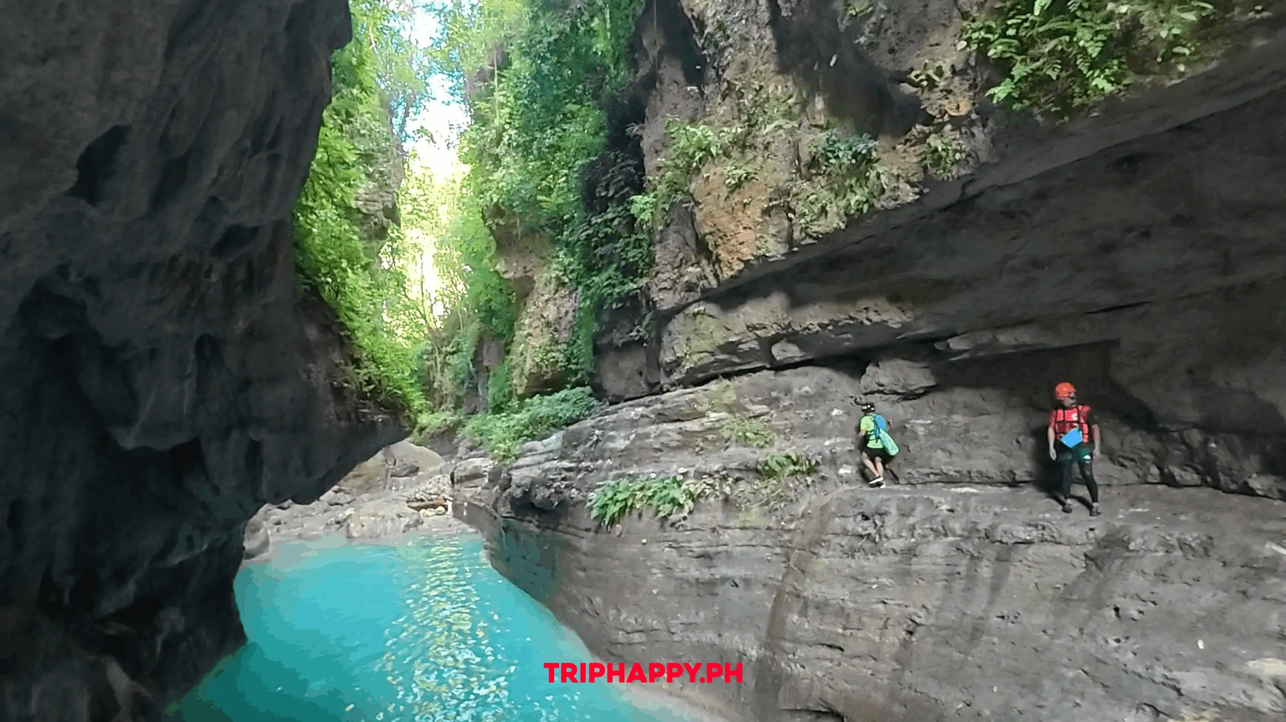 Adventurer walking through the stunning canyon of Kawasan Falls.