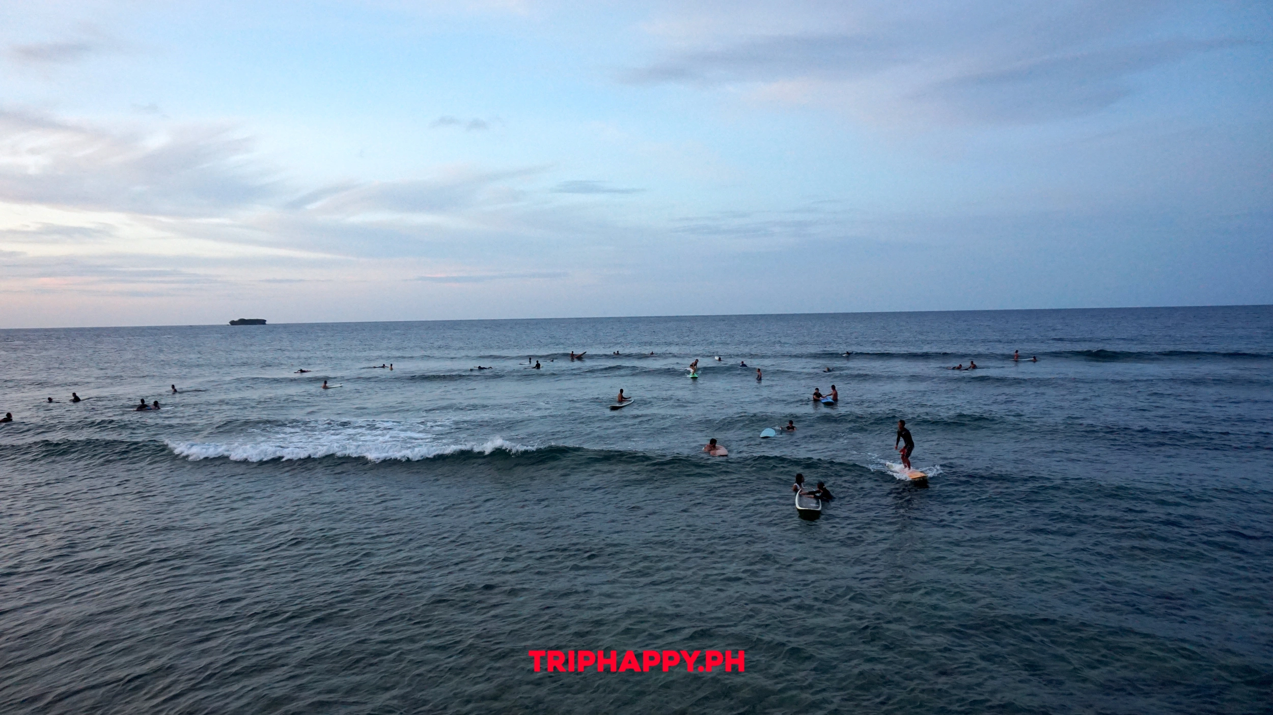 Watch surfers enjoy the waves along Siargao’s beautiful coastline.